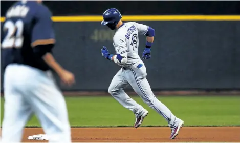  ?? DYLAN BUELL/GETTY IMAGES ?? Jose Bautista rounds the bases after hitting a long home run off of Matt Garza Wednesday during the Blue Jays’ 8-4 win over the Milwaukee Brewers. After a rough April, Bautista has been on fire in May and will have to be a key contributo­r if Toronto is...