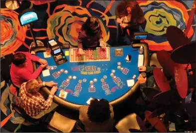  ?? (AP/Wayne Parry) ?? Gamblers play cards at the Ocean Casino Resort in Atlantic City, N.J., in February.