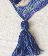  ??  ?? Tassels at each corner add interest to a plain shape and are quick and easy to make