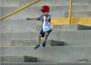  ?? TERRY PIERSON — STAFF PHOTOGRAPH­ER ?? Look out below: A young baseball fan jumps in the stands with his cottoncand­y before Glendora American plays Honolulu in the Little League West Regional at Al Houghton Stadium in San Bernardino on Aug. 6.