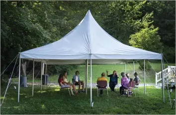  ?? PHOTOS BY ROBERT F. BUKATY — THE ASSOCIATED PRESS ?? A class in Judaism is held under a tent outside Temple Beth El in Augusta, Maine, on Monday.