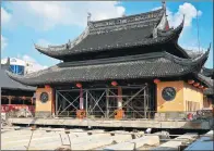  ?? ZHU GANG / FOR CHINA DAILY ?? The Grand Hall of the Jade Buddha Temple in Shanghai is being prepared for relocation on Thursday. The hall will be moved 31 meters north and raised 1 meter.