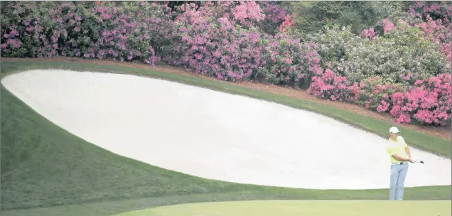  ?? Picture: PHIL NOBLE, REUTERS ?? THE BEAUTY AND THE DANGER: Rory McIlroy chips onto the green of the par-five 13th hole at Augusta during Tuesday’s practice round.