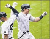  ?? JOHN MINCHILLO — THE ASSOCIATED PRESS ?? Yankees’ Luke Voit, right, celebrates with Aaron Hicks after hitting a solo home run in the first inning.