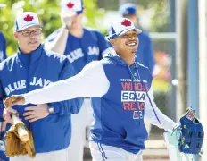  ?? NATHAN DENETTE/THE CANADIAN PRESS ?? Blue Jays starting pitcher Marcus Stroman, right, arrives at spring training in Dunedin, Fla., on Thursday.