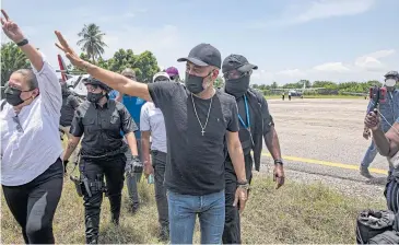  ?? NYT ?? Ex-president Michel Martelly of Haiti, centre, arrives in Les Cayes, Haiti in August last year. Canada announced sanctions on Mr Martelly as part of a broad push to punish officials believed to have ties to the increasing­ly dominant gangs in Haiti.