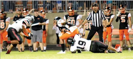  ??  ?? Blackhawk junior Luis Reyes (No. 19) led all tacklers with nine stops in the contest Friday against the Gravette Lions in Gravette.