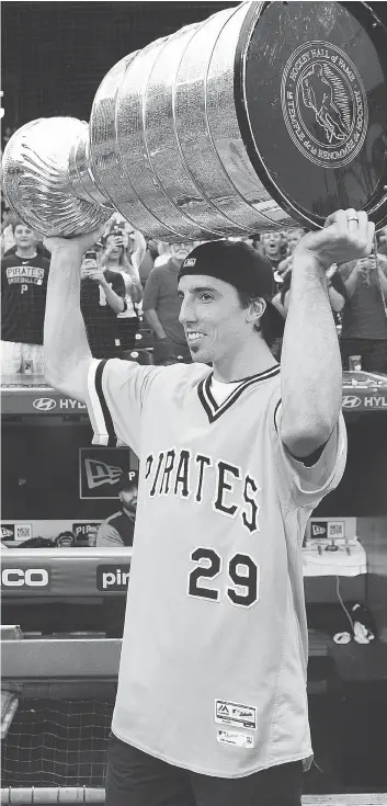  ?? JUSTIN BERL/GETTY IMAGES ?? Penguins goalie Marc-Andre Fleury, celebratin­g with the Stanley Cup at a Pittsburgh Pirates game at PNC Park on Tuesday, is one of the players who will likely be on the move soon to another club.