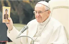  ?? — AFP photo ?? Pope Francis holds up an icon of Sudanese saint Josephine Bakhita during a general audience at the Paul VI Audience Hall at the Vatican.