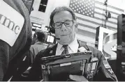  ?? [AP FILE PHOTO] ?? Trader Sal Suarino works on the floor of the New York Stock Exchange.