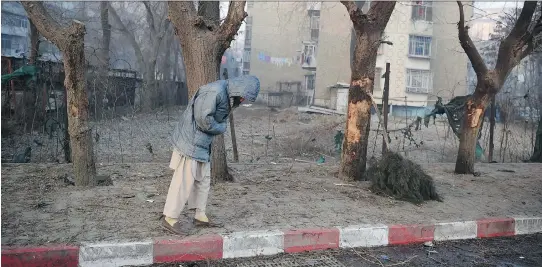  ?? WAKIL KOHSAR/GETTY IMAGES ?? An Afghan resident stands at the site of a suicide bombing in Kabul the day after the Jan. 4 attack. A suicide bomber blew himself up near a crowd of police and protesters, killing at least 11 people and wounding 25 others, officials said, in the...