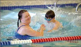  ?? NWA Democrat-Gazette/BEN GOFF • @NWABENGOFF ?? Gina Degnan of Bella Vista and her son Chase Degnan, 7, play in the leisure pool Sunday at the Bentonvill­e Community Center.