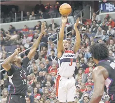  ??  ?? Washington Wizards guard Bradley Beal (centre) shoots the ball over LA Clippers forward Luc Mbah a Moute (left) in the third quarter at Verizon Centre. The Wizards won 117-110. — USA TODAY Sports photo