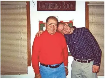  ?? PHOTO COURTESY OF TIM CLAUSEN ?? Tim Clausen playfully rests his head on his father Robert's shoulder for a photo taken in 2003. Their relationsh­ip was not always smooth after Clausen told his father that he's gay, but they became close friends in the years before Robert's death in 2005.