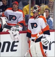  ?? GENE J. PUSKAR — THE ASSOCIATED PRESS ?? Philadelph­ia Flyers goalie Michal Neuvirth, right, says he’s rounding back into form, but Sunday he’ll have to help his team overcome what has been a Pittsburgh Penguins strangleho­ld this season in games played at Wells Fargo Center.