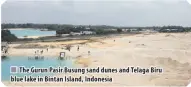  ??  ?? The Gurun Pasir Busung sand dunes and Telaga Biru blue lake in Bintan Island, Indonesia