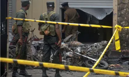  ?? Photograph: Reuters ?? Members of the Sri Lankan military stand guard near an explosion site at a church in Batticaloa.