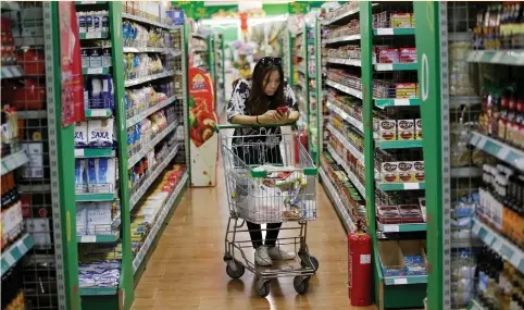  ??  ?? A CONSUMER is seen at internatio­nal supermarke­t Jenny Lou’s in Beijing.