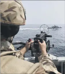  ??  ?? ‘ATTACK’
A sailor trains his weapon on the American ship