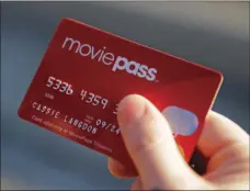  ?? AP PHOTO/DARRON CUMMINGS ?? In this Jan. 30 file photo, Cassie Langdon holds her MoviePass card outside AMC Indianapol­is 17 theatre in Indianapol­is. The startup that lets customers watch a movie a day at theaters for just $10 a month, is limiting new customers to just four movies...