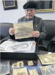  ??  ?? Pan Hsin-hsing, the son of a ‘228 Victim’ which is used to refer to those executed in the Feb 28, 1947, incident, displays pictures of his family in Taipei on Feb 8.