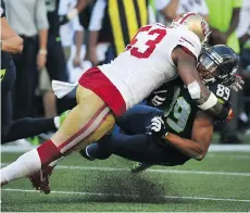  ?? GETTY IMAGES ?? Linebacker NaVorro Bowman of the 49ers tackles Seahawks receiver Doug Baldwin after a catch. Baldwin had eight catches for a career-high 164 yards and a touchdown as the Seahawks won 37-18.