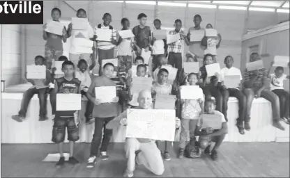  ??  ?? even the carpenter Joseph withstood taunts and tantalise, kept his fiancé, young Anthony Skow (foreground), Peace Corps Volunteer attached to the Bagotville Primary poses with the participan­ts (Rotary Club of Stabroek photo)