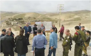  ??  ?? THE KNESSET’S Foreign Affairs and Defense Committee subgroup on Judea and Samaria observes Palestinia­n villages along Route 1 yesterday, near Ma’aleh Adumim.