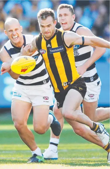  ?? Picture: GETTY ?? BALL MAGNETS: Hawthorn’s Tom Mitchell leads Geelong stars Gary Ablett and Joel Selwood to the ball in the round two AFL match at the MCG yesterday.