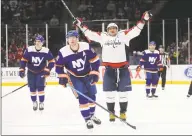  ?? Bruce Bennett / Getty Images ?? Alex Ovechkin (8) of the Washington Capitals celebrates his hat-trick goal into the open net against the New York Islanders at NYCB Live’s Nassau Coliseum on Saturday in Uniondale, N.Y. The Capitals won 6-4.