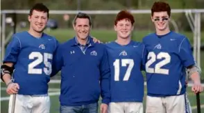  ?? JIM DAVIS/GLOBE STAFF ?? Mike Clayton (second from left) with sons — Tyler (No. 25), Tristan (No. 17) and Trey (No. 22) — of Acton-Boxborough lacrosse (11-3).