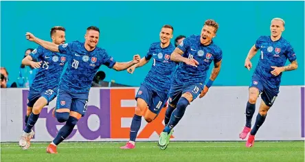  ?? AFP ?? Slovakian players celebrate goal against Poland in their Euro Group ‘E’ football match at the Saint Petersburg Stadium in Russia on Monday.—