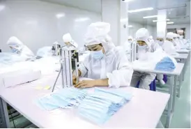  ?? — AFP photo ?? China’s ramp-up of mask production to counter the coronaviru­s outbreak has claimed unlikely victims – nappies, wet wipes and sanitary towels that are made with the same raw material.