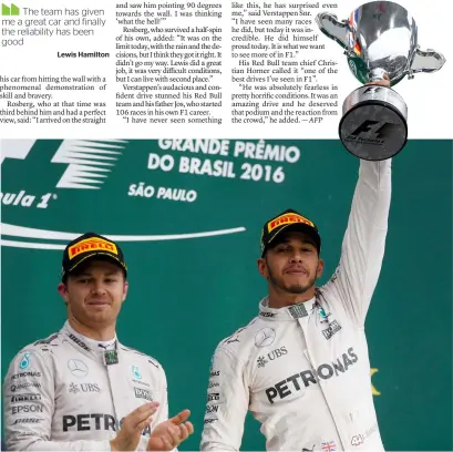  ?? AP ?? Rosberg applauds as Hamilton celebrates with his trophy after winning the Brazilian GP. —