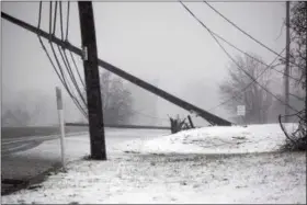  ?? MARIAN DENNIS — DIGITAL FIRST MEDIA ?? High winds and snowfall made for a tricky commute home Friday as telephone poles and trees were knocked down. Many areas also suffered power outages as a result of the storm.