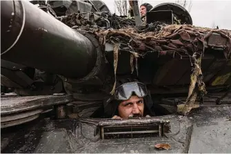  ?? Evgeniy Maloletka/Associated Press ?? A Ukrainian serviceman sits in a tank Monday near Bakhmut, Ukraine. Russian forces have been unable to deliver a knockout blow that would allow them to seize Bakhmut.
