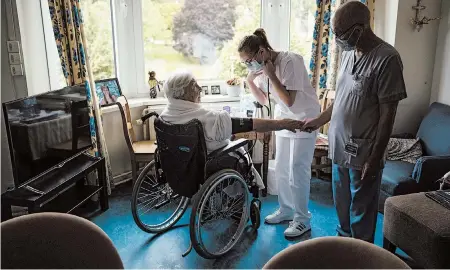  ?? FRANCISCO SECO/AP ?? Nurse Jean-Claude Feda, right, and trainee Lyson Rousseau take the blood pressure of Odette Defraigne-Schmit in July at a nursing home in Belgium.