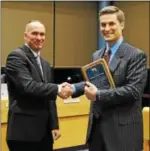  ?? SUBMITTED PHOTO — COURTESY OF MONTGOMERY TOWNSHIP ?? Retiring Montgomery Township police Sgt. Dan Mitchell, left, shakes hands with township Supervisor Robert Birch after Mitchell was recognized for 33 years with the department on Feb. 27.