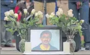  ?? REUTERS ?? A picture of Srinivas Kuchibhotl­a, who was recently shot and killed in Kansas, is surrounded by roses during a vigil in honour of him at Crossroads Park in Washington, US, on Sunday.