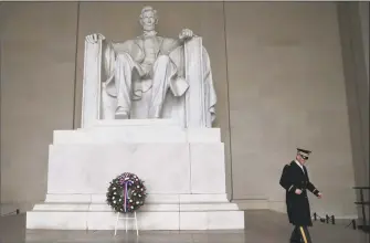  ?? Getty Images ?? A member of a U.S. Military Honor Guard walks away after a full honor wreath-laying ceremony to commemorat­e the 210th birthday of President Abraham Lincoln, at the Lincoln Memorial, this week.