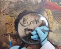  ??  ?? Art restoratio­n specialist­s wear surgical masks and use modern technology such as X-ray and ultraviole­t machines, to uncover images that have faded away in time on canvases that average 300 years old.