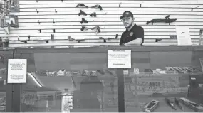  ?? FRED SQUILLANTE/COLUMBUS DISPATCH ?? Metal Gear Armory manager Tyler Hendricks shows the empty wall racks and shelving that used to be fully stocked with ammo and guns at his store in Lancaster on Friday.