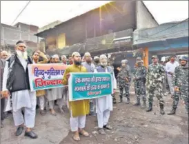  ?? SANCHIT KHANNA/HT PHOTO ?? People seen holding banners calling for peace after last week's riots. Several private trusts have set up n mobile ambulances with doctors, medicines and first-aid for victims.