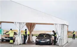  ?? —AFP ?? In this file photo, Danish police controls drivers from Sweden near the highway coming out of the tunnel to Sweden, in Copenhagen, Denmark. More than two months after the closure of its border, Denmark has loosened restrictio­ns to allow lovers from the Nordics and Germany to reunite, but the applicatio­n and legality of the practice has not really helped economy to recover.