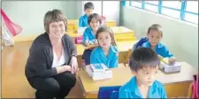  ??  ?? Carin Holroyd visits with students in school in Vietnam.