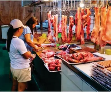  ?? (Photo.) ?? WIDENING GAP. Pork is sold from PHP330 to PHP380 per kilo at Agdao Public Market in Davao City on March 19, 2024. According to the Philippine Chamber of Agricultur­e and Food, the farmgate price of pig for slaughter ranged only between PHP140 and PHP160 per kilo.