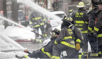  ?? ASHLEE REZIN GARCIA/SUN-TIMES ?? Chicago firefighte­rs battle a blaze in Belmont Cragin in January.