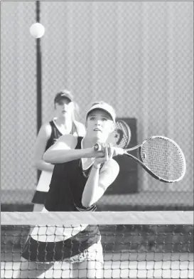  ??  ?? Asberri Freeman looks on as her doubles partner, Madison Harris, tries to backhand a return during last week’s match at Ringgold. (Messenger photo/ Scott Herpst)