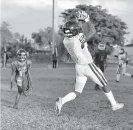  ?? MICHAEL LAUGHLIN/SUN SENTINEL ?? TRU Prep Academy receiver Fredrick Cage catches a TD pass against Akelynn’s Angels Christian Academy during the first half of their game on Sept. 24, 2020. Cage is one of the local players planning to sign on National Signing Day on Wednesday.