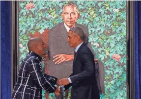  ?? SAUL LOEB/AFP/GETTY IMAGES ?? Kehinde Wiley, left, created a presidenti­al portrait of Barack Obama that was unveiled at the National Portrait Gallery in Washington on Feb. 12, 2018. Wiley’s work shows black men in positions of power.